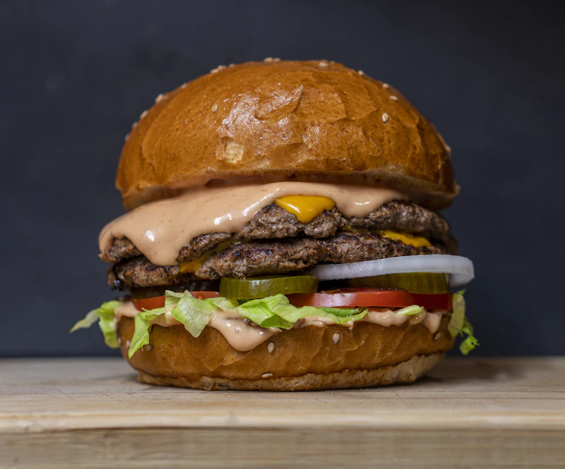 House burger with fries on a wooden table