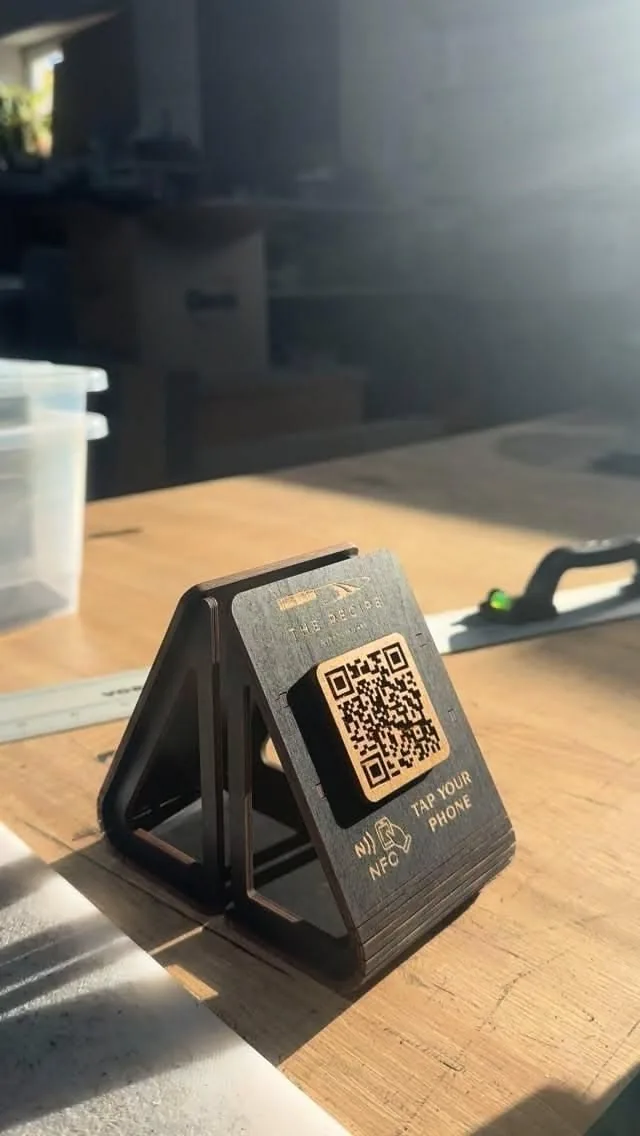 Laser-cut wooden NFC tent with tap-your-phone mark